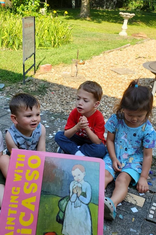 kids sitting and listening to a picasso book being read