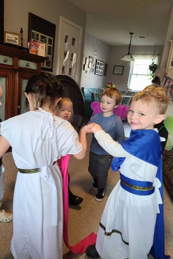 Kids in costumes acting out a Shakespeare play