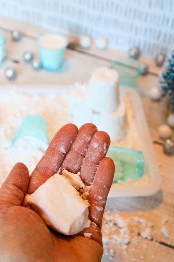fake snow in a hand pressed together
