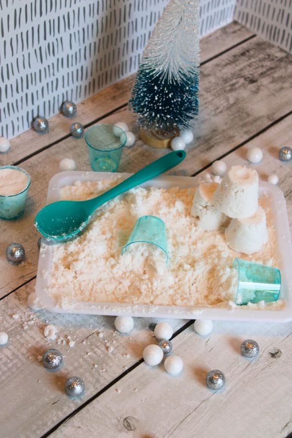 fake snow on a tray with snow toys
