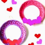 heart wreaths made of paper plates with hearts sprinkled around