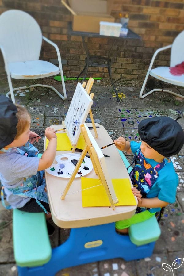 kids painting on canvas with oil paints
