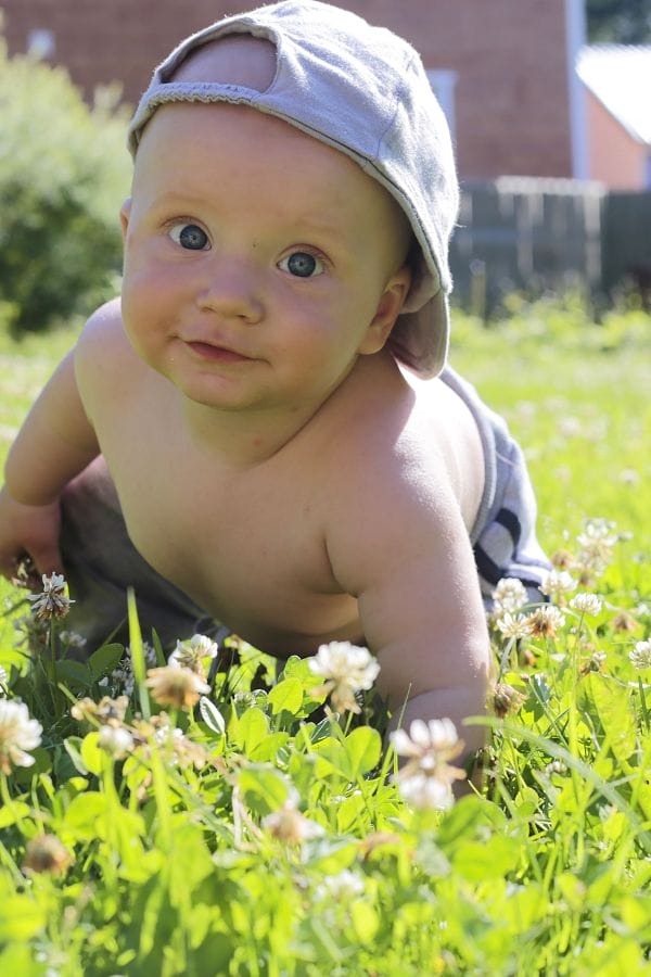 a baby crawling in the grass