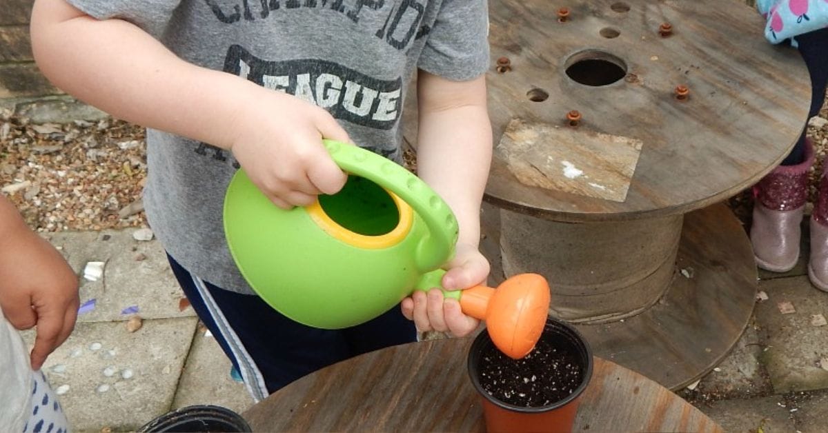 a child watering a pot
