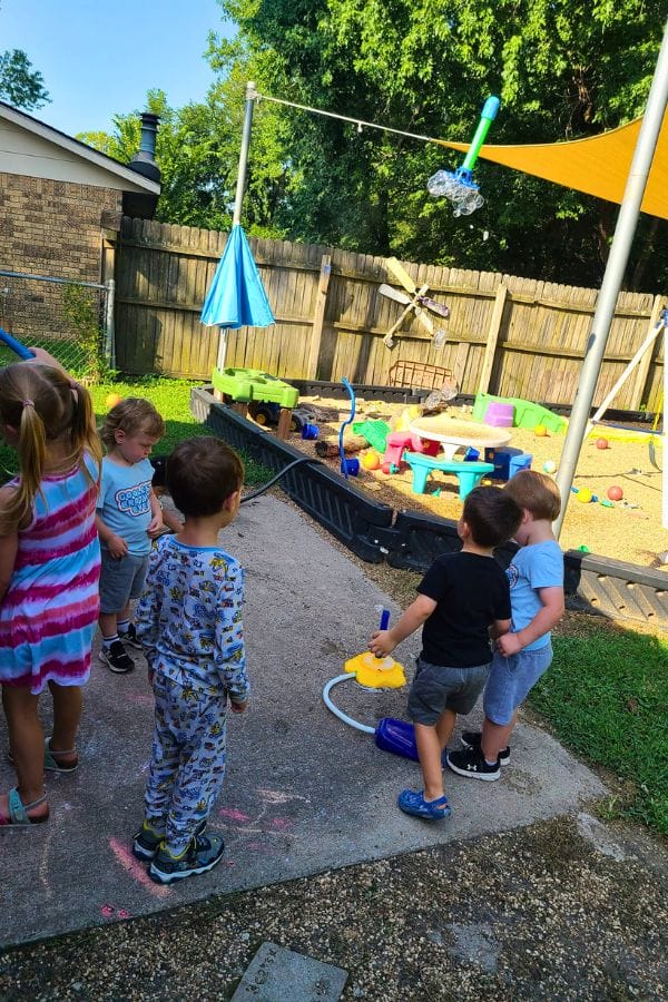 a group of kids using a bubble stomp rocket