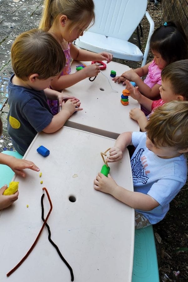 daycare kids making sculptures with pipe cleaners and clay