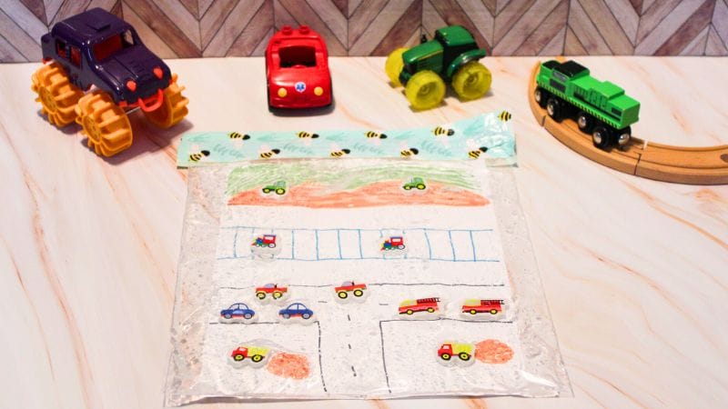 transportation sensory bag activity on a board with trucks