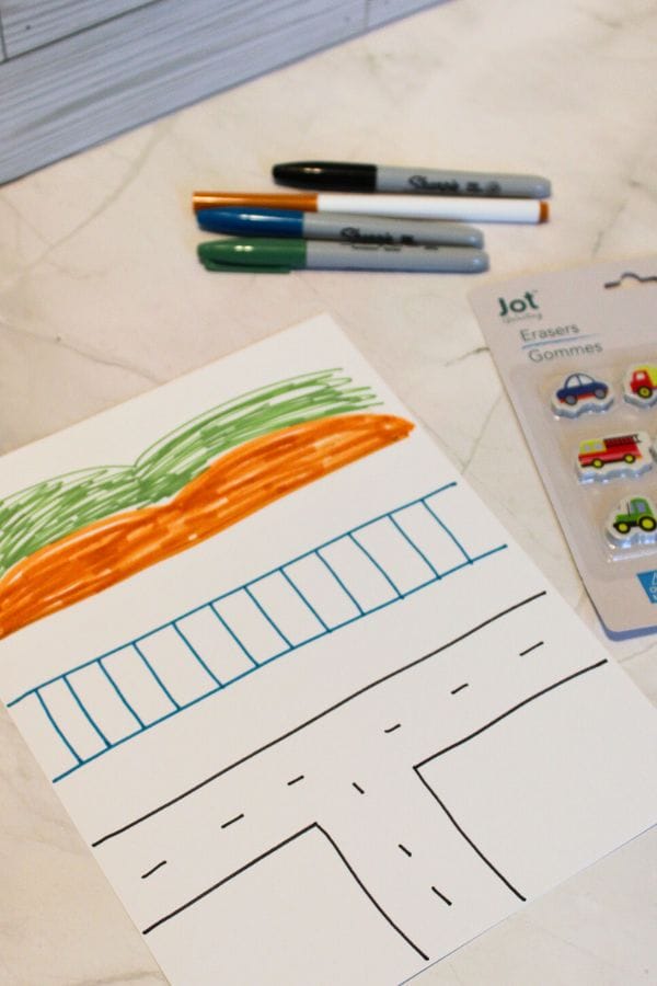 drawing a transportation scene with roads and tracks for a sensory bag