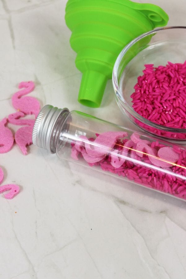 a pink flamingo sensory bottle with pink rice