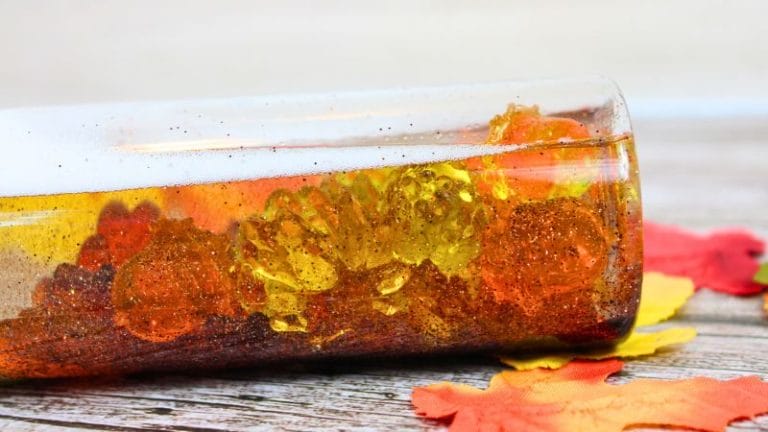 an easy fall sensory bottle on its' side on a board