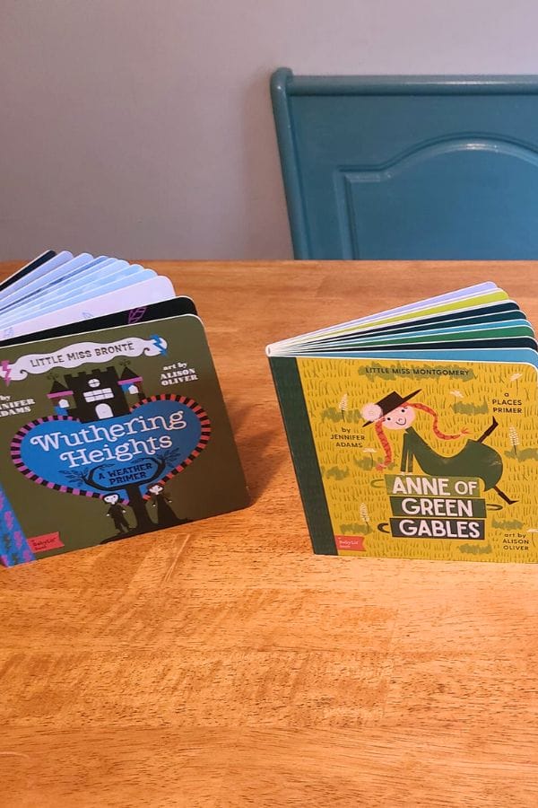 Two children's board books rest on a wooden table, perfectly setting the scene for a classic literature themed tea party: "Wuthering Heights" and "Anne of Green Gables.