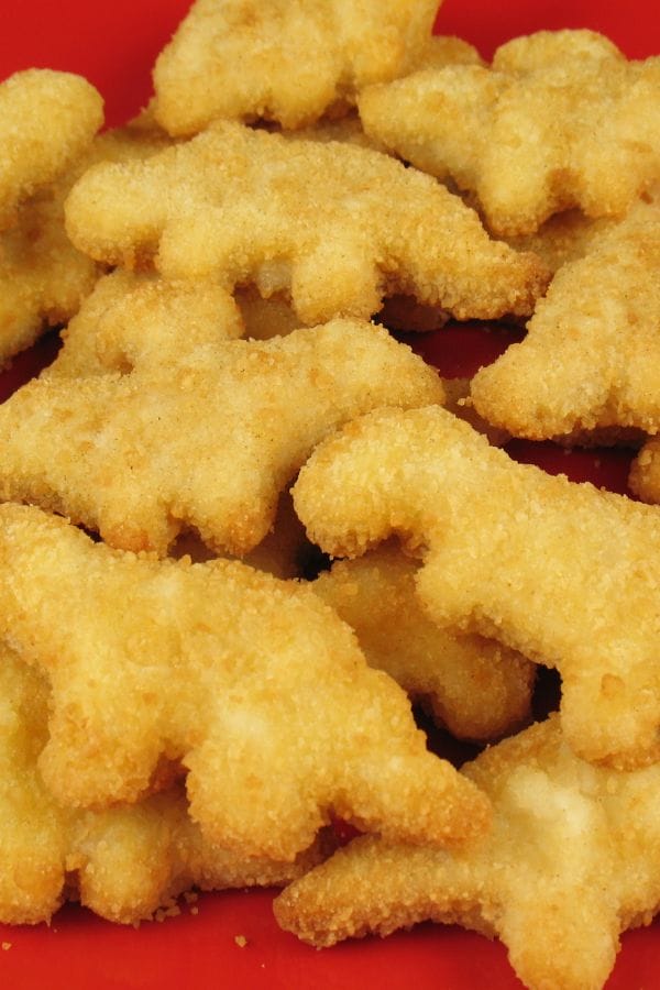 Discover the delight of our breaded chicken nuggets, expertly shaped like dinosaurs and served on a vibrant red plate. These fun bites not only promise smiles but also come with CN Labels for CACFP, ensuring they meet nutritious standards.