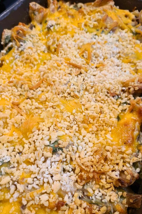 A sour cream and onion tuna casserole topped with melted cheese and a layer of crushed crackers.
