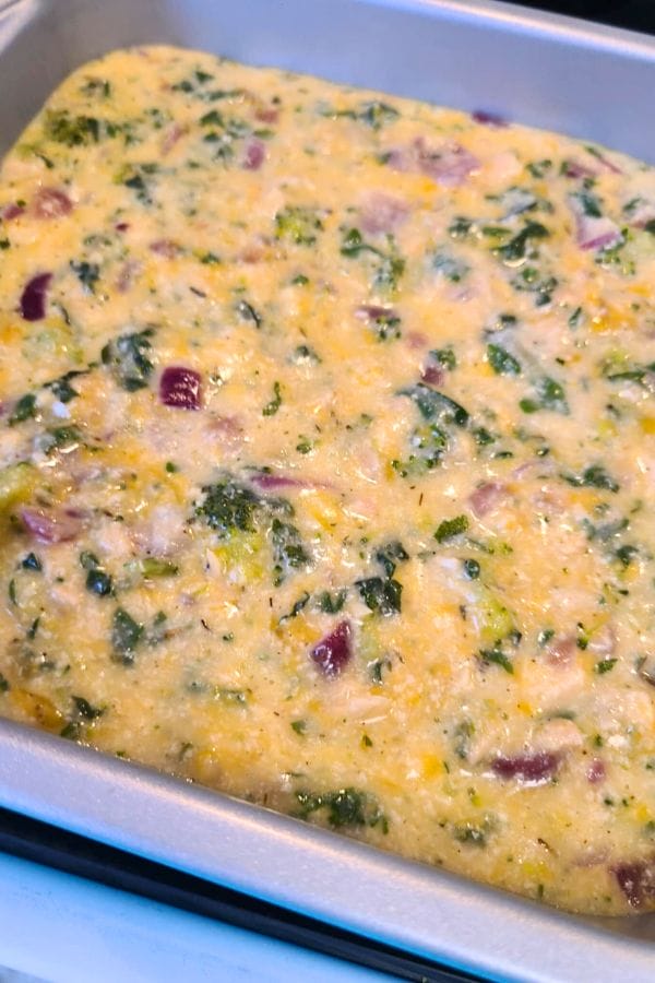A delightful baking dish combining a colorful mixture of vegetables, cheese, and beaten eggs, reminiscent of a classic tuna biscuit casserole for a modern twist.