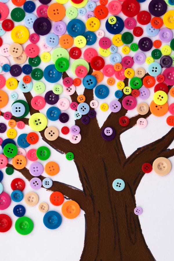 In a whimsical representation of nature, a tree with a brown trunk and branches is adorned with colorful buttons as leaves. It's akin to a page from daycare lesson plans on Pete the Cat, sparking imagination and creativity.