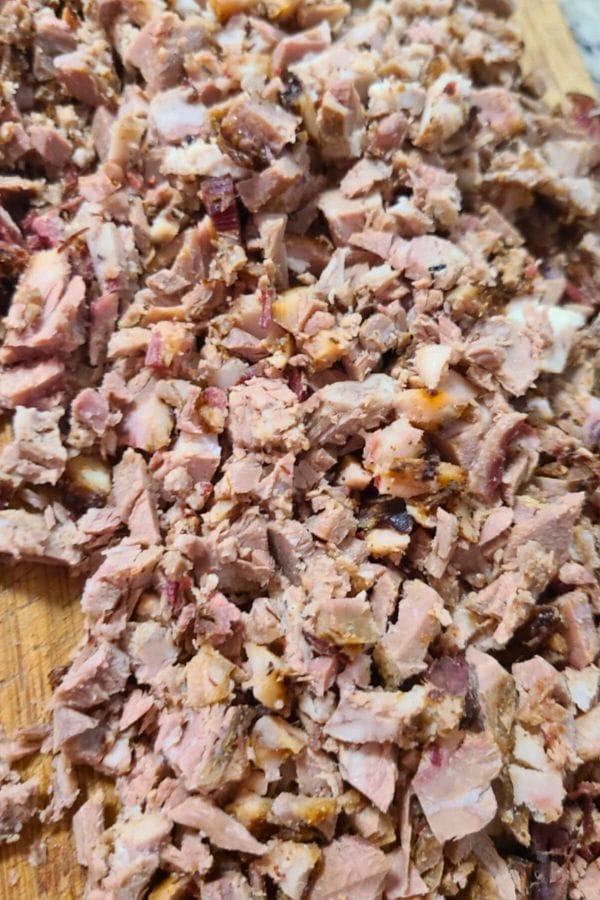 Leftover Brisket Chili ingredients, chopped cooked meat pieces are spread on a wooden cutting board, ready for your next delicious meal.
