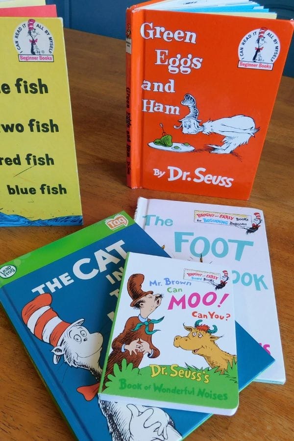 A selection of Dr. Seuss books, including "Green Eggs and Ham," "The Cat in the Hat," and more, displayed on a wooden table—perfect for inspiring lesson plans on The Cat in the Hat and other classics.