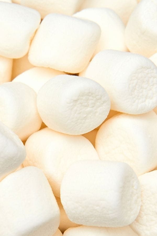 A close-up view of several white marshmallows stacked together, perfect for an Easy Snowman Craft.