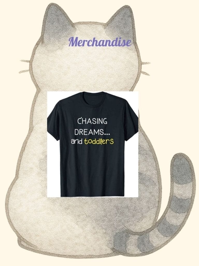 A black t-shirt with the text "Chasing dreams... and toddlers" displayed on a background featuring a gray cartoon cat and the word "Merchandise" at the top.